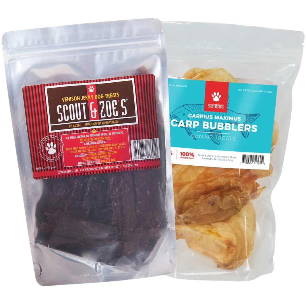 Two packages of dog treats, one labeled 'Scout & Zoe's Venison Jerky' and the other 'Maximus Maximus Carp Bubblers', each in clear packaging showing the respective dog treats inside.